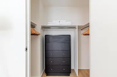 a closet with a black door and a shelf at Blueground Chelsea rooftop pool nr The Vessel NYC-2147 in New York