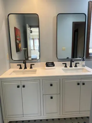 a bathroom with two sinks and two mirrors at Lake Naomi Retreat Family Fun & Games in Pocono Pines