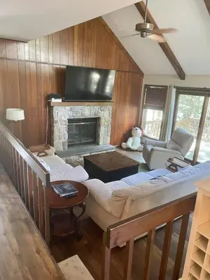 a living room with a couch and a fireplace at Lake Naomi Retreat Family Fun & Games in Pocono Pines