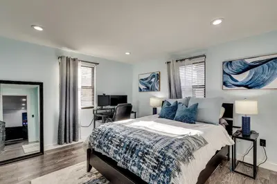a bedroom with a bed and a desk in it at 4 Mi to MetLife Stadium Modern Retreat! in Wallington