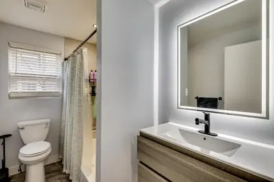 a bathroom with a sink and a toilet at 4 Mi to MetLife Stadium Modern Retreat! in Wallington