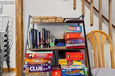 a book shelf filled with lots of books at Hot Tub + Fire Pit • Game Room • Community Pool in Tobyhanna