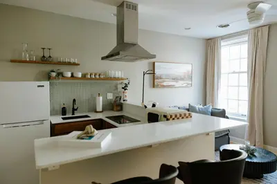 a kitchen with a white counter top and a refrigerator at The Citizen Suite - Downtown in Lancaster