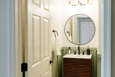 a bathroom with a sink and a mirror at The Citizen Suite - Downtown in Lancaster