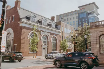 a black car parked in front of a brick building at Maisonette on Duke - Downtown in Lancaster