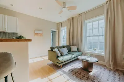 a living room with a couch and a table at Maisonette on Duke - Downtown in Lancaster
