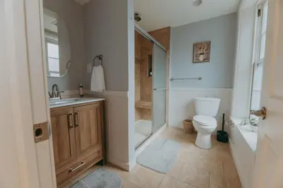 a bathroom with a toilet and a shower and a sink at Maisonette on Duke - Downtown in Lancaster