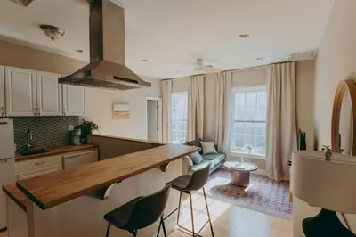 a kitchen with a counter and chairs in a room at Maisonette on Duke - Downtown in Lancaster