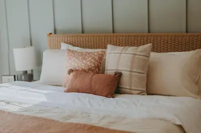 a bed with a bunch of pillows on it at Maisonette on Duke - Downtown in Lancaster