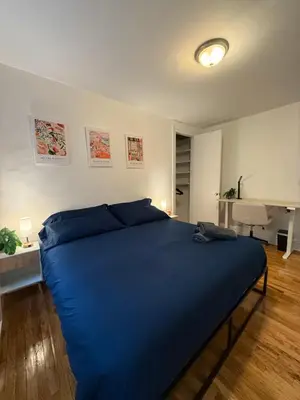 a bed in a room with a blue blanket on it at The Broadway Escape - Private Room in Times Square in New York