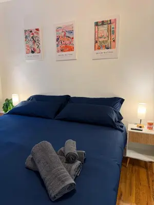 a bed with blue sheets and towels on it at The Broadway Escape - Private Room in Times Square in New York