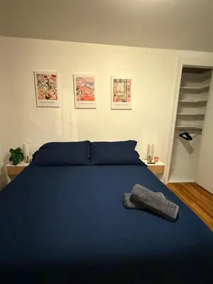 a bedroom with a blue bed with a sock on it at The Broadway Escape - Private Room in Times Square in New York