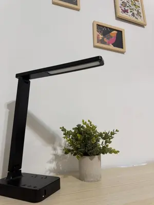 a black lamp sitting on a table next to a plant at The Broadway Escape - Private Room in Times Square in New York