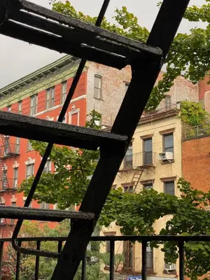 a view of a building from behind a metal fence at Cosy apartment in prime West Village in New York