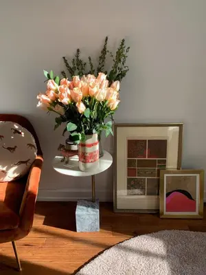 a vase of flowers on a table in a living room at Cosy apartment in prime West Village in New York