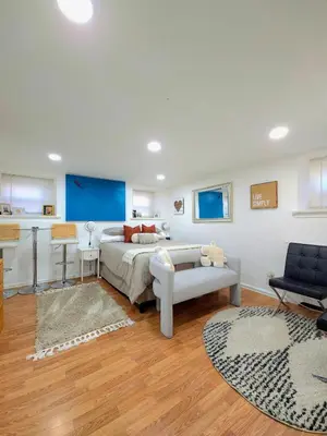 a bedroom with a bed and a couch and a chair at Sunny Oak Lane Studio Near Einstein, LaSalle, Center City in Philadelphia