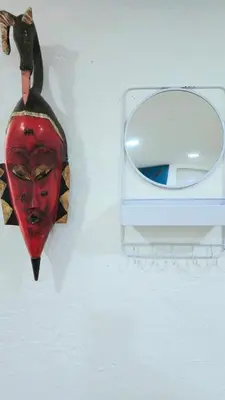 a mask and a mirror on a wall at Sunny Oak Lane Studio Near Einstein, LaSalle, Center City in Philadelphia