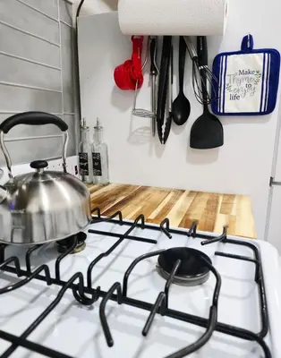 a tea kettle on a stove in a kitchen at Sunny Oak Lane Studio Near Einstein, LaSalle, Center City in Philadelphia