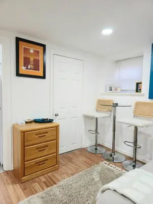 a bedroom with a bed and two bar stools at Sunny Oak Lane Studio Near Einstein, LaSalle, Center City in Philadelphia