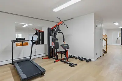 a room with a gym with two tread machines at Family Staycation Retreat 7BDR Sauna Games