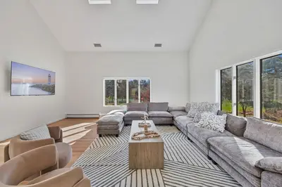 a living room with a couch and a table at Family Staycation Retreat 7BDR Sauna Games