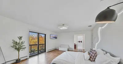 a white room with a bed and a lamp at Family Staycation Retreat 7BDR Sauna Games