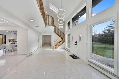 a large white hallway with a staircase and a dining room at Family Staycation Retreat 7BDR Sauna Games