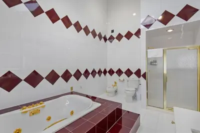 a bathroom with a tub and a shower and a toilet at Family Staycation Retreat 7BDR Sauna Games