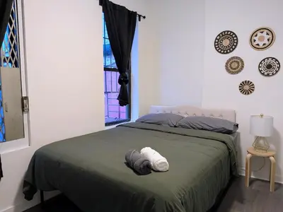 a bedroom with a bed with two towels on it at The Black Bellvue NYC in New York