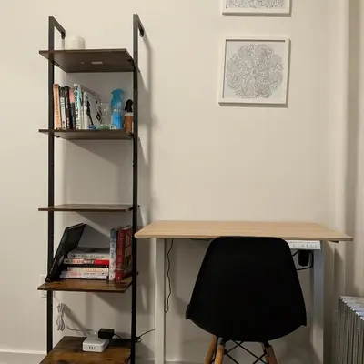 a desk with a chair next to a book shelf at The Black Bellvue NYC in New York