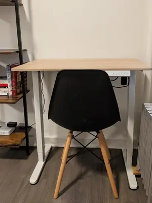 a black chair sitting at a wooden desk at The Black Bellvue NYC in New York