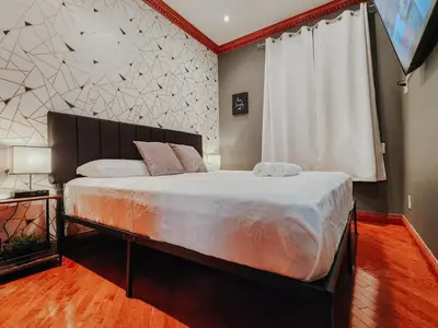 a bedroom with a large bed and a window at IceCream - Pool Table - 120 Projector - King Bed in Philadelphia