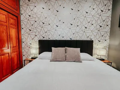 a bedroom with a bed with two pillows on it at IceCream - Pool Table - 120 Projector - King Bed in Philadelphia