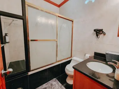 a bathroom with a toilet and a sink and a shower at IceCream - Pool Table - 120 Projector - King Bed in Philadelphia