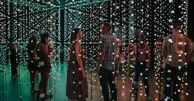 a group of people standing in front of christmas lights at IceCream - Pool Table - 120 Projector - King Bed in Philadelphia