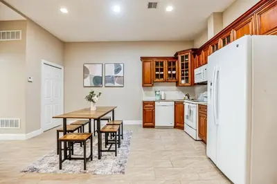 a kitchen with a table and a refrigerator at Luxury 3 Bedroom - Perfect Center City Location in Philadelphia