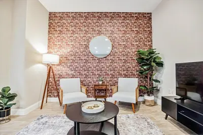 a living room with two chairs and a brick wall at Luxury 3 Bedroom - Perfect Center City Location in Philadelphia