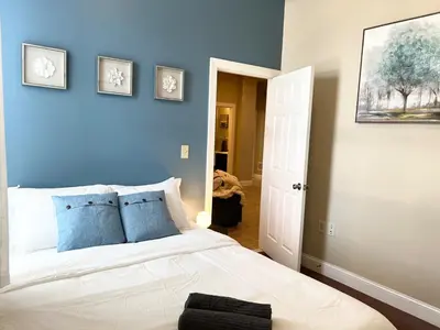 a bedroom with blue walls and a bed with blue pillows at Luxury 3 Bedroom - Perfect Center City Location in Philadelphia