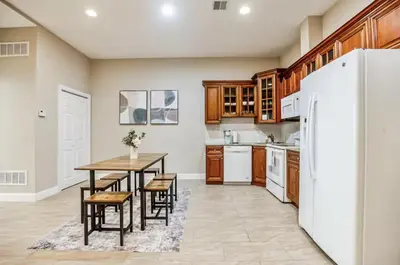 a kitchen with a table and a refrigerator at Luxury 3 Bedroom - Perfect Center City Location in Philadelphia