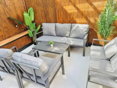a living room with a couch and a table and chairs at Family-Friendly 2BR, NYC Access in Minutes in Hoboken