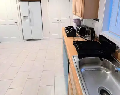 a kitchen with a sink and a counter top at Family-Friendly 2BR, NYC Access in Minutes in Hoboken