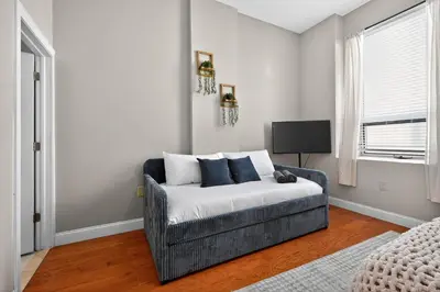 a living room with a couch and a television at Luxury 3 Bedroom - Perfect Center City Location - 501 in Philadelphia