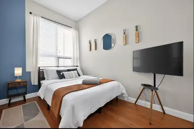 a bedroom with a bed and a flat screen tv at Luxury 3 Bedroom - Perfect Center City Location - 501 in Philadelphia