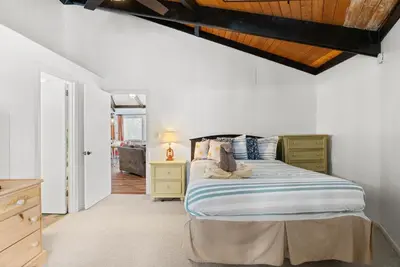 a bedroom with a bed with a wooden ceiling at Chic 2 BD 2 BA Near Skiing Fireplace etc in Pocono Pines