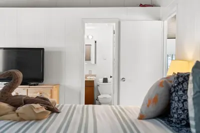 a bedroom with a bed with a tv and a bedskirtspectspectspectspects at Chic 2 BD 2 BA Near Skiing Fireplace etc in Pocono Pines