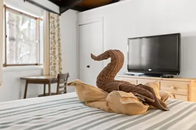 a stuffed snake sitting on top of a bed at Chic 2 BD 2 BA Near Skiing Fireplace etc in Pocono Pines