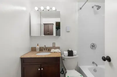 a bathroom with a sink and a toilet and a shower at Chic 2 BD 2 BA Near Skiing Fireplace etc in Pocono Pines