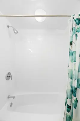 a shower with a green shower curtain at Chic 2 BD 2 BA Near Skiing Fireplace etc in Pocono Pines