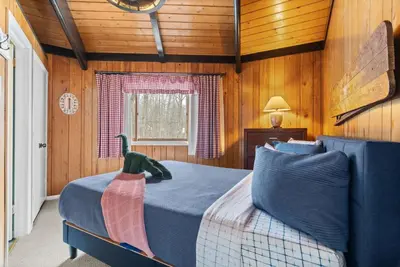 a bedroom with a bed with a dinosaur on it at Chic 2 BD 2 BA Near Skiing Fireplace etc in Pocono Pines
