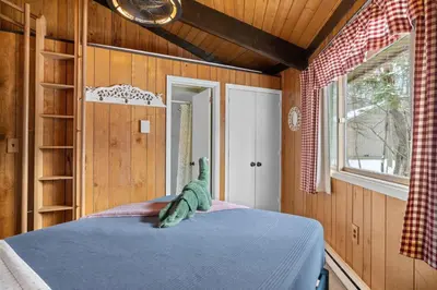 a bedroom with a bed with a stuffed animal on it at Chic 2 BD 2 BA Near Skiing Fireplace etc in Pocono Pines